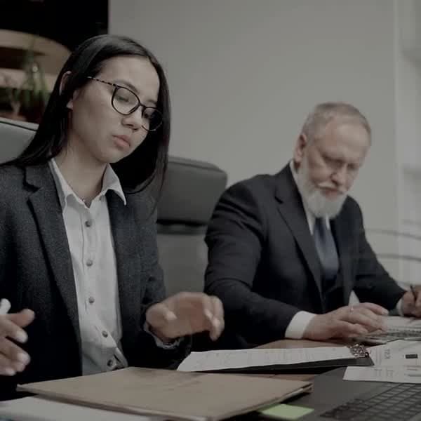 Counsel reviewing documents together at a meeting table